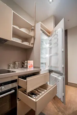 a kitchen with an open refrigerator with its door open at Sentire Hotels & Residences Taksim in Istanbul