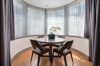 a table and chairs in a room with windows at Sentire Hotels & Residences Taksim in Istanbul