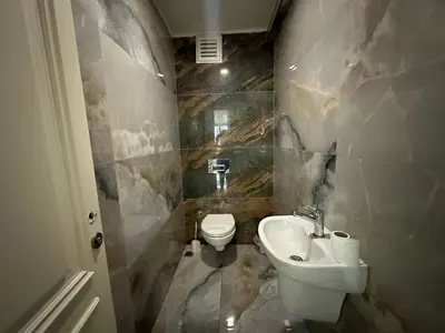 a small bathroom with a toilet and a sink at Gold Suit in Istanbul