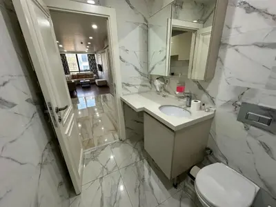 a bathroom with a sink and a shower and a toilet at Gold Suit in Istanbul