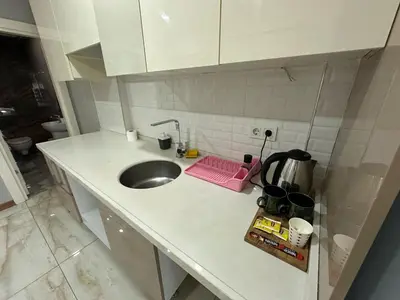 a kitchen counter with a sink and a pink tray at Gold Suit in Istanbul