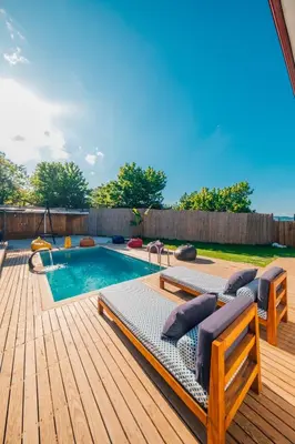 a swimming pool with two lounge chairs and a wooden deck at tetova in Sapanca