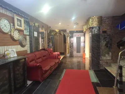 a living room with a couch and clocks on the wall at Sword Hotel in Avcılar