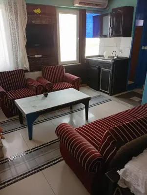 a living room with two couches and a coffee table at Sword Hotel in Avcılar