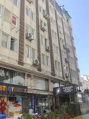 a tall building on a city street with a store at Sword Hotel in Avcılar