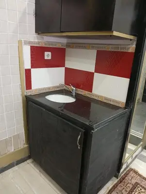 a sink in a bathroom with a red and white wall at Sword Hotel in Avcılar