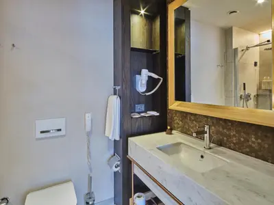 a bathroom with a sink and a phone on the wall at Four-G Hotel Premium in Istanbul