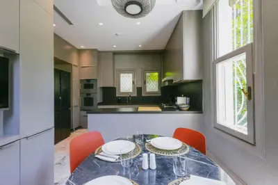 a kitchen with a dining table with chairs and a counter at Eva Bosphora Waterfront Living in Istanbul