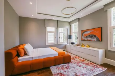 a bedroom with an orange bed and a couch at Eva Bosphora Waterfront Living in Istanbul