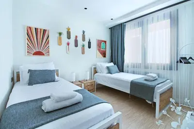 a bedroom with two beds and a window at Excellent Apartments Fatih Nova in Istanbul