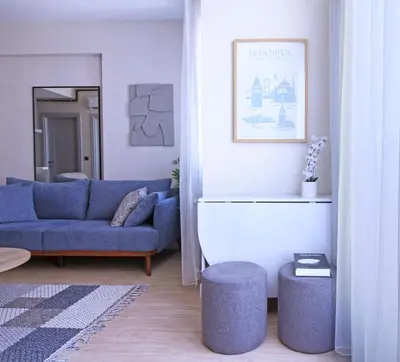 a living room with a blue couch and a blue chair at Excellent Apartments Fatih Nova in Istanbul