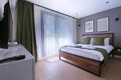a bedroom with a bed and a large window at Excellent Apartments Fatih Nova in Istanbul