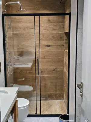 a shower with a glass door in a bathroom at Excellent Apartments Fatih Nova in Istanbul