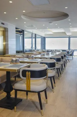 a row of tables and chairs in a restaurant at Lions Royal Hotel in Istanbul