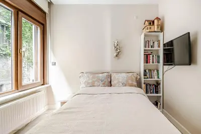 a bedroom with a bed and a book shelf at Luxury Seaside Apartment with Bosphorus View in Sarıyer in Sarıyer