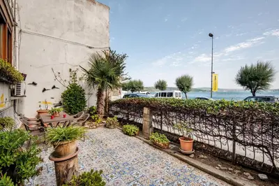 a garden with a bench and a fence with plants at Luxury Seaside Apartment with Bosphorus View in Sarıyer in Sarıyer