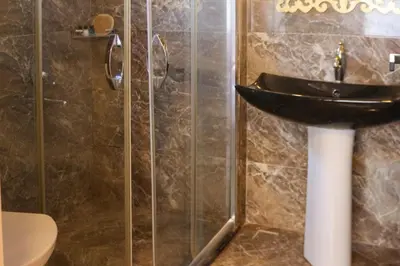 a bathroom with a sink and a glass shower at Mints Hotel Ağva in Agva