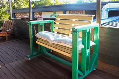 a wooden bench sitting on a deck at Mints Hotel Ağva in Agva