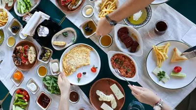 a table full of plates of food with people at Mints Hotel Ağva in Agva