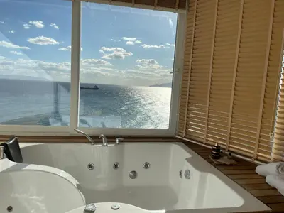 a bathroom with a tub and a large window at iskele rum butik otel in Tekirdag