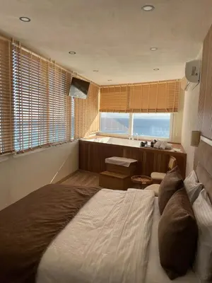 a bedroom with a large bed and a window at iskele rum butik otel in Tekirdag
