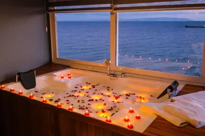 a bath tub with lights in front of a window at iskele rum butik otel in Tekirdag