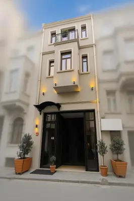 a building with two potted plants in front of it at Utarit Hotel in Istanbul