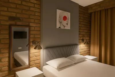 a bedroom with a white bed and a mirror at Utarit Hotel in Istanbul