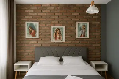 a bedroom with a brick wall and a bed at Utarit Hotel in Istanbul