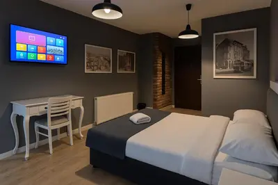 a bedroom with a bed and a desk and a tv at Utarit Hotel in Istanbul