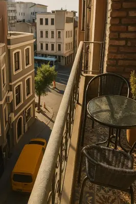 a balcony with a table and a table and chairs at Utarit Hotel in Istanbul