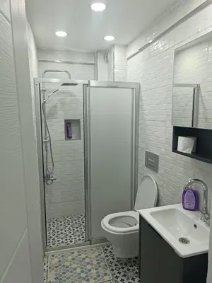 a bathroom with a shower and a toilet and a sink at Üsküdar'da Tam Size Göre S in Istanbul