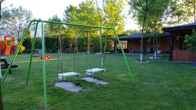 a park with a swing set in the grass at Sapanca Cayir Cimen Otel in Sapanca