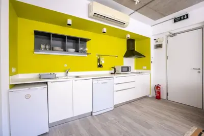 a kitchen with white cabinets and a yellow wall at Cool Charming Central 1BD1Bath Modern Home! #398 in Istanbul