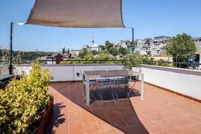 a patio with a table and chairs on a roof at Cool Charming Central 1BD1Bath Modern Home! #398 in Istanbul