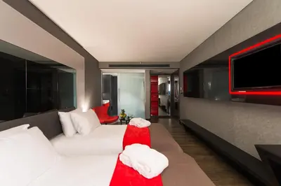 a living room with a white couch and a flat screen tv at Hotel Favori Nisantasi in Istanbul