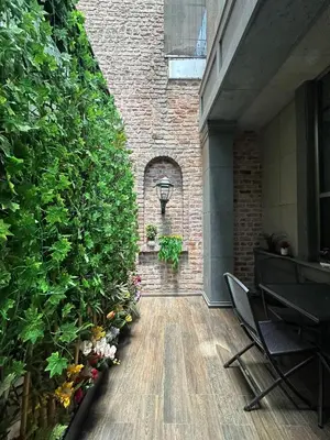 a hallway with a plant wall and a table and chairs at Hotel Favori Nisantasi in Istanbul