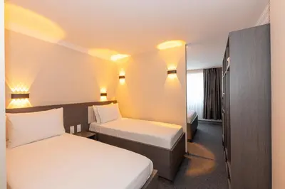 a hotel room with two beds and a mirror at Mays Otel in Istanbul