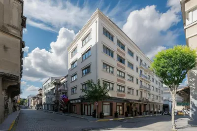a white building on a street in a city at Mays Otel in Istanbul