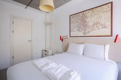 a white bedroom with a white bed with a map on the wall at Cozy Coastal Hideaway with Bosphorus Breeze! #399 in Istanbul