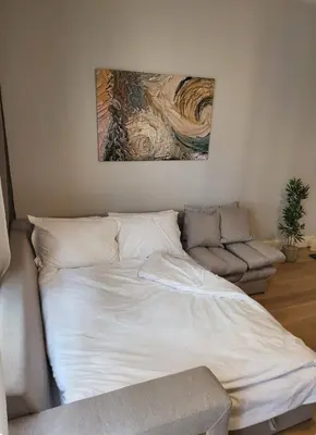 a bed in a room with a painting on the wall at Taksim The 360 Hearth Of İstanbul 55-56 in Istanbul
