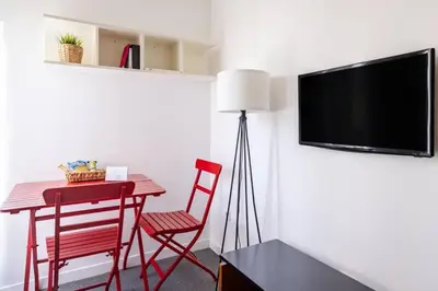 a room with a table and chairs and a flat screen tv at Stunning Serene 2BD1Bath Bosphorus Retreat! #400 in Istanbul