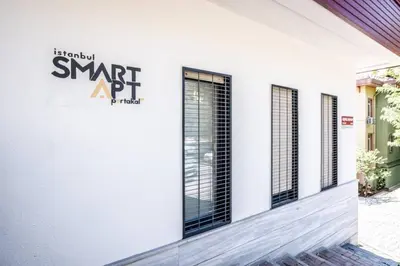 a white building with black windows and a sign on it at Stunning Serene 2BD1Bath Bosphorus Retreat! #400 in Istanbul