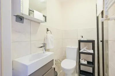 a white bathroom with a sink and a toilet at Casa Nozze 2 in Istanbul