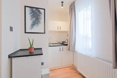 a kitchen with white cabinets and a window at Casa Nozze 2 in Istanbul