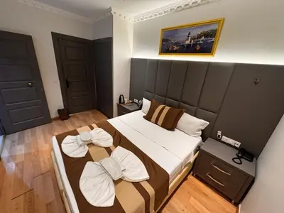 a bedroom with a large bed with two pillows on it at Blue Istanbul Hotel Taksim in Istanbul