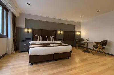 a bedroom with a large bed and a desk at Blue Istanbul Hotel Taksim in Istanbul