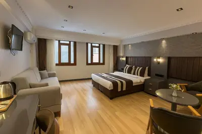 a bedroom with a bed and a living room at Blue Istanbul Hotel Taksim in Istanbul