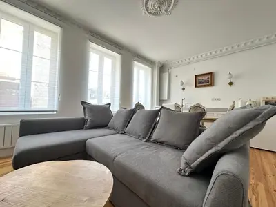 a living room with a gray couch and a table at Balatella Suites in Istanbul