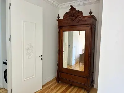 an antique mirror in a room with a white wall at Balatella Suites in Istanbul
